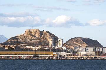Alicante harbor with santa barbara castle and scenic mountain background