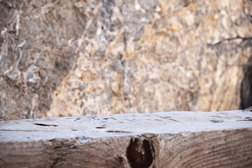 Close-up of weathered wooden surface against stone background for natural texture design