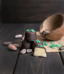 Handmade chocolate candies with filling on dark background
