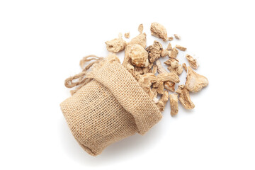 Close-up of Dry Organic Ginger Root (Zingiber officinale) or sonth, spilled out from a laying jute bag. Isolated on a white background.