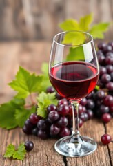 Rich red wine in a glass, grapes on rustic wood, vineyard, food
