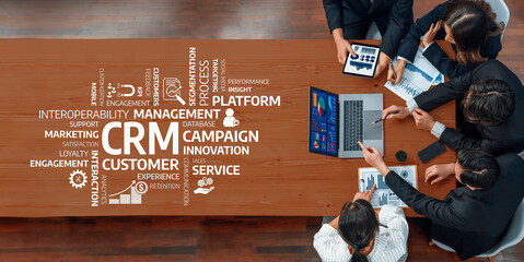 Aerial view of a diverse team engaged in a strategic meeting focused on customer relationship management, showcasing innovative ideas and effective collaboration within a modern workspace. Amity