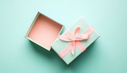 Opened gift box with red bow on yellow background, top view