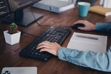 Female professional coding on a computer workstation in a home office with casual style