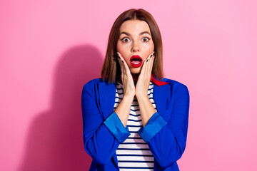 Portrait of a stylish young woman expressing surprise against a pink background