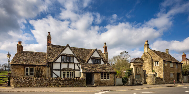 Traditional medieval house and WW1 memorial in the historic village of Lacock, Wiltshire, England, Uk	