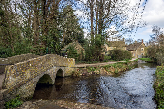 Old stone bridge over the River Avon at Lacock, Wiltshire, England, Uk