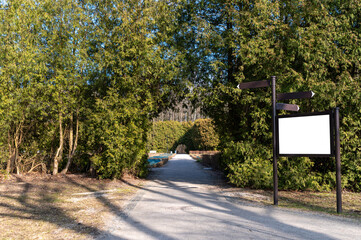 Pathway leading to a serene outdoor area surrounded by lush greenery and clear skies