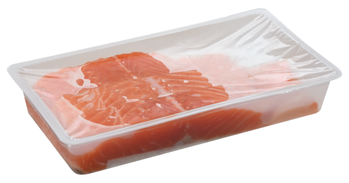 Slices of raw salmon fillets are packaged in a clear plastic tray, sealed with transparent film. Isolated background
