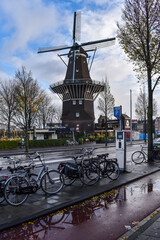Famous De Gooyer Windmill with side-ride bicycles with reflection in a pan, Amsterdam NETHERLANDS