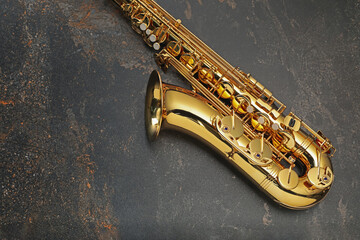 Obraz premium Jazz. One saxophone on black textured table, top view. Space for text