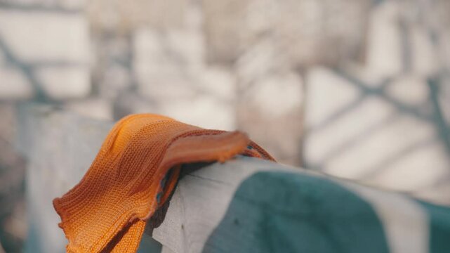 Tired Worker Throws Orange Gloves on Wooden Surface in Slow Motion - Construction Site Frustration Close-up