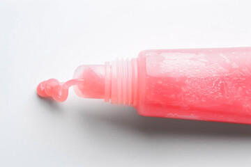 Tube of lip balm on white background, top view