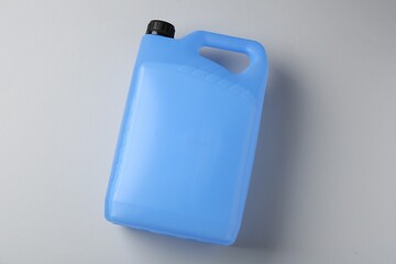Antifreeze in plastic canister on grey background, top view