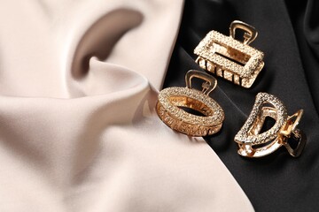 Beautiful hair clips on fabrics, above view. Space for text