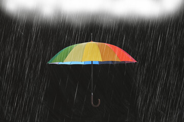 Bright umbrella protecting from pouring rain on black background