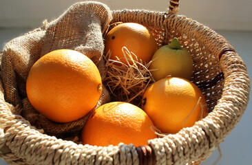 Citrus Fruit Basket with Domestic Decor on a Sunlit Table. Sunny Day at Home Kitchen with Fruits...