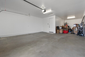 An open garage filled with many boxes on the floor
