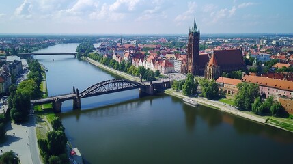 Fototapeta premium Aerial view of a city with a river running through it and bridges connecting both sides of the city