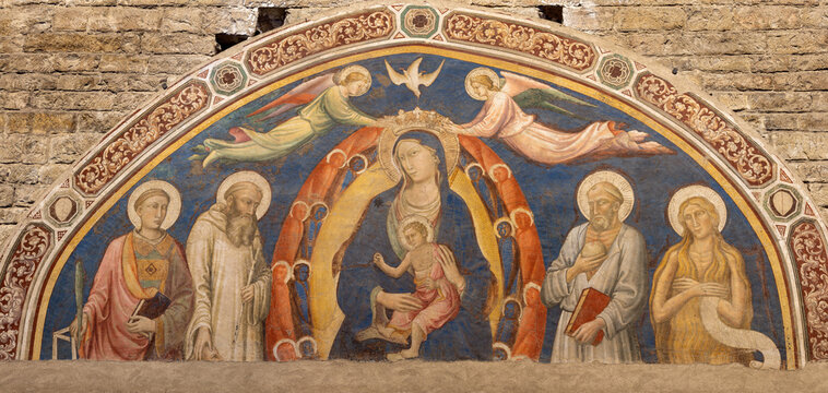 FLORENCE, ITALY - MARCH 19, 2025: The mnedieval fresco of Madonna (queen) among the sanits in the church Basilica San Miniato al Monte Maestro della Sant'Agata (cca 1260).