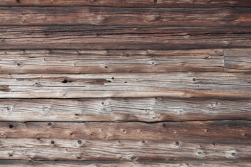 Texture of old half-rotten logs of a wooden house wall, useful as background