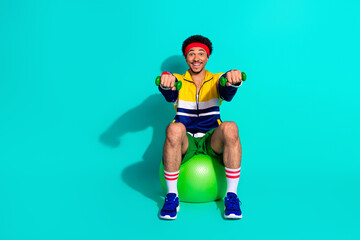 Young man exercising with retro style activewear on a teal background, featuring vibrant colors