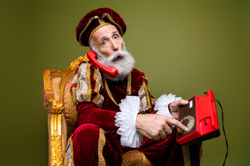 A stylish nobleman in vintage attire uses a rotary dial telephone, combining historical and modern...