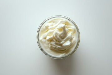 A top-down view of a glass bowl filled with creamy yogurt, isolated on a white background, inviting a fresh and healthy vibe.