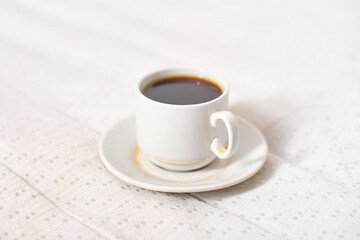 Steaming coffee cup on soft fabric surface
