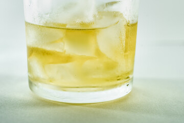 Whisky Close up with ice dark strong shadows light with a white background