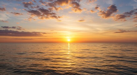 Obraz premium Sunset over the ocean with colorful clouds reflecting on the water surface.