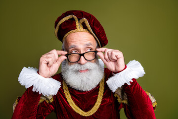 Elderly man in medieval noble costume with expressive pose, retro khaki background