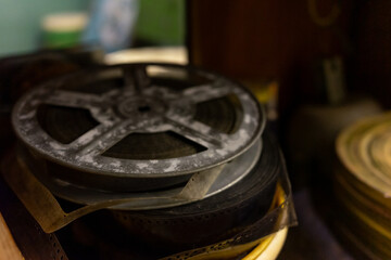 Old film reels stacked in a vintage storage space