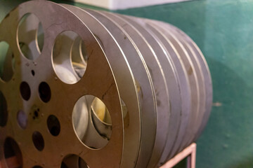 Vintage film reels stacked in a retro cinema storage area