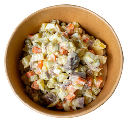 Tasty vegetable salad with creamy dressing in a wooden bowl