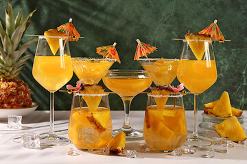 Various alcoholic drinks with pineapple for bar advertising. Lemonade royal cocktail, martini,...