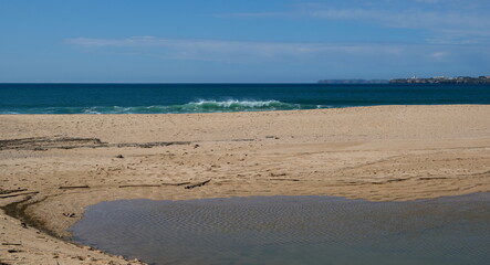 green atlantic wave on a sandy beach