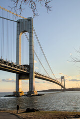 view of verrazzano bridge with water in river at new york city harbor (suspension structure between bay ridge brooklyn and staten island) nyc landmark sunset cloudy vista tourism travel
