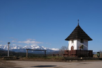 Naklejka premium Viewpoint of High Tatras and Bialskie Tatras on Pass over Lapszanka with old white chapel.
