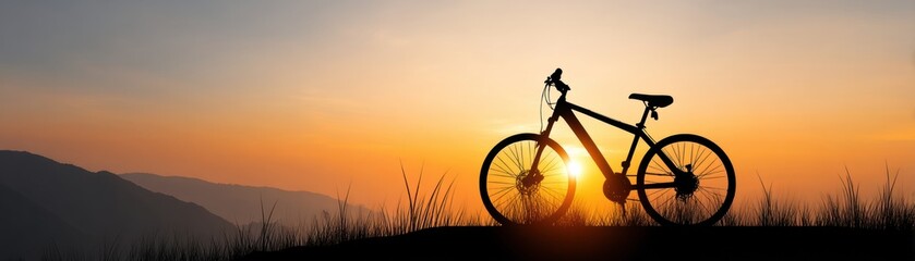 Fototapeta premium A silhouette of a bicycle against a vibrant sunset backdrop, highlighting the beauty of nature and outdoor adventure.