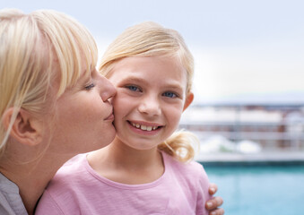 Portrait, kiss and mother with daughter outside for bonding, happiness and care on holiday. Smile,...