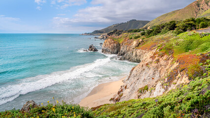 Big Sur, California, boasts a dramatic and rugged coastline, where the Santa Lucia Mountains plunge into the Pacific Ocean. The Pacific Coast Highway (Highway 1) winds along the rugged coast line