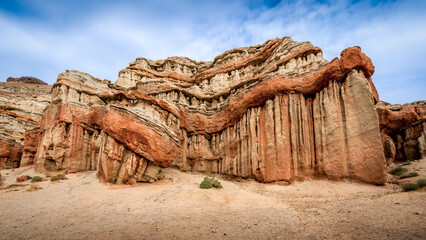 Red Rock Canyon State Park in California is a stunning landscape characterized by dramatic red rock formations, rugged cliffs, and a unique desert environment.