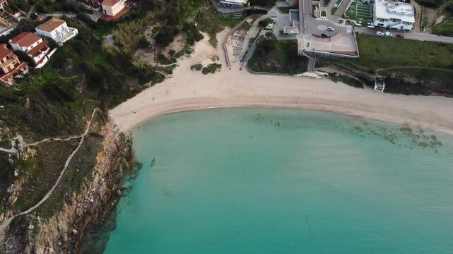 Ascending aerial view of the Spiaggia Rena Bianca beach in Santa Teresa Gallura, Sardinia, Italy