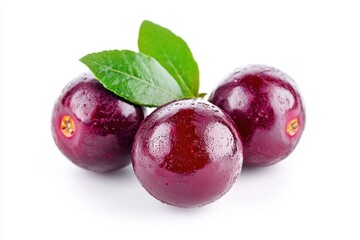 Fototapeta premium Three dark purple plums with leaves