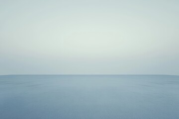 Obraz premium Aerial view of a wide plain with sparse clouds scattered across the sky.