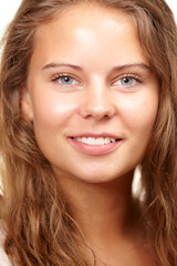 Obraz premium Woman, portrait and smile in studio for beauty, cosmetics and facial treatment on white background. Happy female person, smile and confidence for skincare or dermatology, wellness and glow in closeup