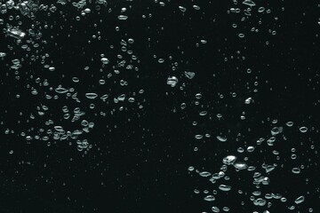 Many water bubbles on black background, closeup