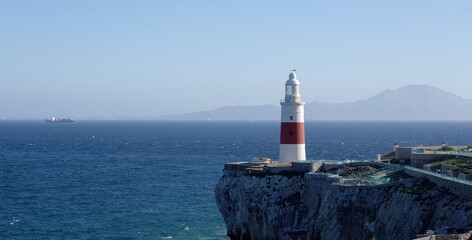 Europa Point Lighthouse guiding ships near Gibraltar, United Kingdom, with Morocco in the background