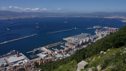 Obraz premium Gibraltar harbor with ships sailing on a sunny day with blue sky